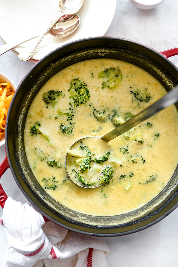 cheesy potato soup with broccoli in serving dish with ladle