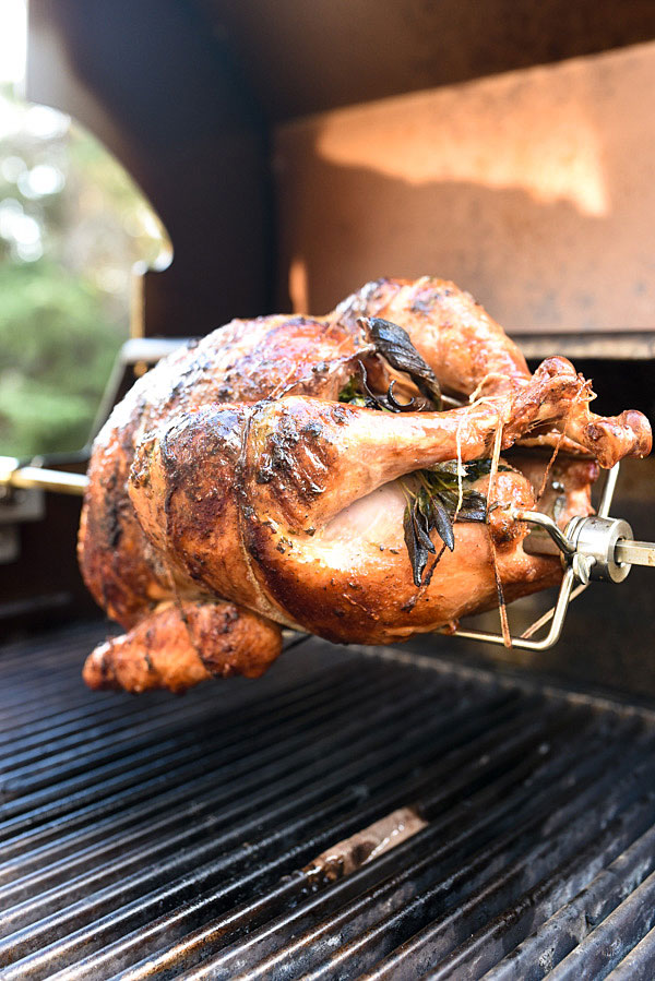 Rotisserie Herb Butter Turkey cooking over a grill