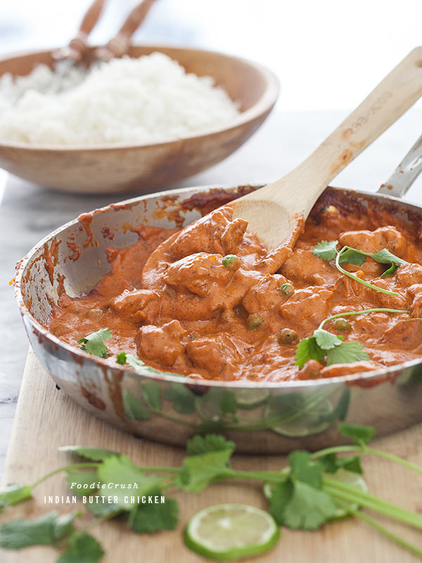 Indian butter chicken in metal skillet with fresh cilantro