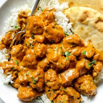 Indian Butter Chicken over rice with naan in bowl foodiecrush.com