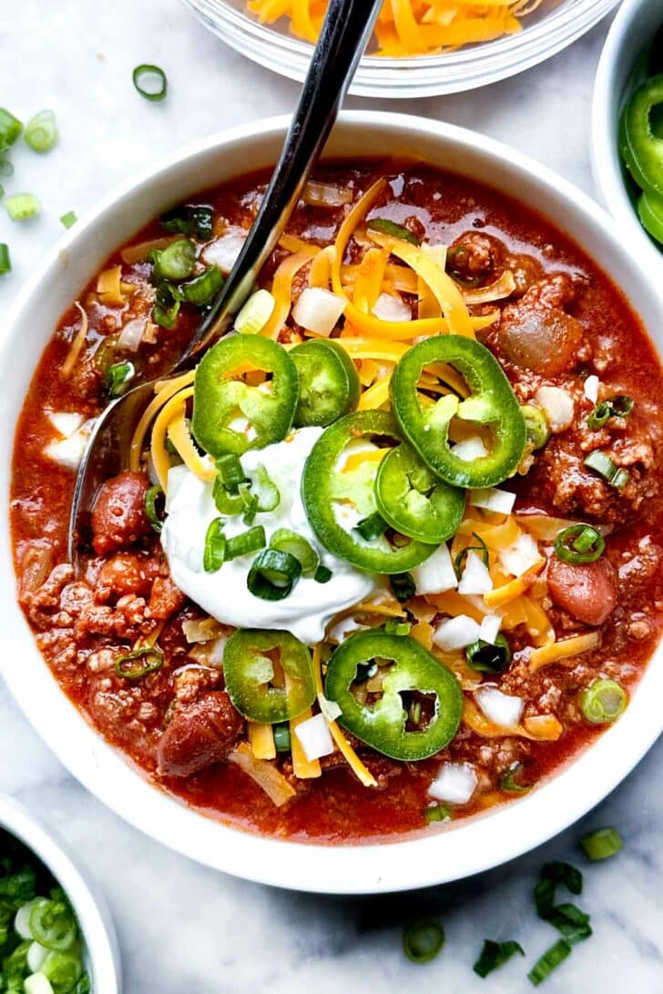 How to Make THE BEST Beef Chili recipe in bowl with spoon foodiecrush.com #chili #recipe #beef